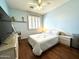 Cozy bedroom with wood floors, ceiling fan, and a white-themed decor for a peaceful retreat at 1131 W Sierra Madre Ave, Gilbert, AZ 85233