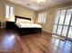 Bright bedroom with gleaming hardwood floors and plantation shutters for natural light control at 1131 W Sierra Madre Ave, Gilbert, AZ 85233