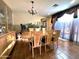 Spacious dining area featuring tile floors, and modern lighting fixtures, with large bright window at 1131 W Sierra Madre Ave, Gilbert, AZ 85233