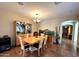 Bright dining room with modern lighting, neutral paint, ceramic tile flooring, and decorative aquarium at 1131 W Sierra Madre Ave, Gilbert, AZ 85233