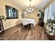 Formal dining room featuring modern lighting, beautiful flooring, plantation shutters and decorative plants at 1131 W Sierra Madre Ave, Gilbert, AZ 85233