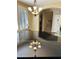 Formal dining room featuring modern lighting, plantation shutters, and reflective piano adding style to the space at 1131 W Sierra Madre Ave, Gilbert, AZ 85233