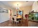 Bright dining room with modern lighting, neutral paint, ceramic tile flooring and decorative aquarium at 1131 W Sierra Madre Ave, Gilbert, AZ 85233