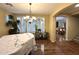 Bright dining room with hardwood floors, shuttered windows, and a view into another room at 1131 W Sierra Madre Ave, Gilbert, AZ 85233