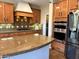 Close-up of the kitchen featuring granite countertops, tile backsplash, and stainless steel appliances at 1131 W Sierra Madre Ave, Gilbert, AZ 85233