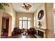 Inviting living room with plush leather armchairs, plantation shutters, hardwood floors, and a fireplace at 1131 W Sierra Madre Ave, Gilbert, AZ 85233