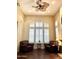 Cozy living room with plush leather armchairs, plantation shutters, hardwood floors and a decorative ceiling fan at 1131 W Sierra Madre Ave, Gilbert, AZ 85233