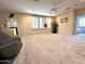 Bright living room featuring neutral-toned walls, plush carpet, and plantation shutters for adjustable lighting at 1131 W Sierra Madre Ave, Gilbert, AZ 85233