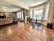 An open living room with a tile floor, plantation shutters, and view into the living room at 1131 W Sierra Madre Ave, Gilbert, AZ 85233