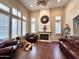 Elegant living room with hardwood floors, fireplace, and abundant natural light from large windows at 1131 W Sierra Madre Ave, Gilbert, AZ 85233