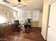 Bright home office with wood floors, plantation shutters, and ample desk space for productivity at 1131 W Sierra Madre Ave, Gilbert, AZ 85233