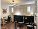 Well-lit home office features laminate wood flooring, unique light fixture, and plantation shutters at 1131 W Sierra Madre Ave, Gilbert, AZ 85233