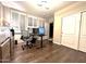 Well-lit home office features hardwood flooring, modern desk, and plantation shutters at 1131 W Sierra Madre Ave, Gilbert, AZ 85233