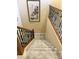 Elegant staircase featuring wood and wrought iron railings, plush carpet, and decorative artwork at 1131 W Sierra Madre Ave, Gilbert, AZ 85233