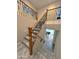 Stylish staircase with wood and wrought iron railings, soft carpeting, and a glimpse of the living room below at 1131 W Sierra Madre Ave, Gilbert, AZ 85233