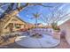 Spacious backyard features a covered patio, outdoor seating, a fire pit, and desert landscaping, ideal for entertaining at 1157 W Desert Lily Dr, San Tan Valley, AZ 85143