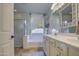 Bathroom featuring double sinks, a soaking tub, and a window at 1157 W Desert Lily Dr, San Tan Valley, AZ 85143