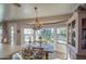 Cozy dining area with natural light, chandelier, and a decorative hutch at 1157 W Desert Lily Dr, San Tan Valley, AZ 85143