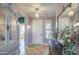 Welcoming foyer with decorative mirror, elegant chandelier, and neutral tile flooring at 1157 W Desert Lily Dr, San Tan Valley, AZ 85143