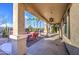 Relaxing covered patio with outdoor seating, desert landscaping, and decorative hanging lights at 1157 W Desert Lily Dr, San Tan Valley, AZ 85143