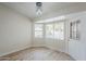 Cozy bedroom featuring new flooring, large windows with pool view, and access to backyard at 126 S Rita Ln, Chandler, AZ 85226