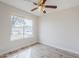 Bright bedroom with a ceiling fan and street view window at 126 S Rita Ln, Chandler, AZ 85226