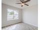 Cozy bedroom with wood-look flooring and large window at 126 S Rita Ln, Chandler, AZ 85226