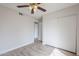 Bright bedroom featuring wood-look flooring, neutral walls, and a ceiling fan at 126 S Rita Ln, Chandler, AZ 85226