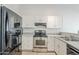 Modern kitchen showcasing stainless steel appliances, white cabinetry, and efficient layout at 126 S Rita Ln, Chandler, AZ 85226