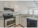 Modern kitchen features stainless steel oven, white cabinets, and sleek countertops at 126 S Rita Ln, Chandler, AZ 85226