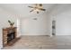 Inviting living area with brick fireplace, ceiling fan, and access to kitchen area at 126 S Rita Ln, Chandler, AZ 85226