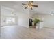 Bright, open-concept living room boasts new floors, modern ceiling fan, and ample natural light at 126 S Rita Ln, Chandler, AZ 85226