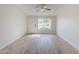 Clean and bright living room with modern flooring, a window, and a neutral color palette at 126 S Rita Ln, Chandler, AZ 85226