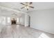 Bright living room featuring high ceilings, hardwood floors, and a traditional brick fireplace at 126 S Rita Ln, Chandler, AZ 85226