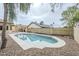 Backyard pool area surrounded by desert landscaping, shade trees, and block fence at 126 S Rita Ln, Chandler, AZ 85226