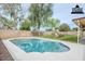 Inviting backyard pool with well-maintained landscaping, stone retaining walls, and seating area at 126 S Rita Ln, Chandler, AZ 85226