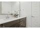 Bathroom with dual sinks, quartz countertops, dark wood cabinets, and modern fixtures at 12660 E Pivot Peak --, Gold Canyon, AZ 85118