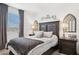 Comfortable bedroom featuring a dark wood bed frame, stylish lamps, and neutral decor at 12660 E Pivot Peak --, Gold Canyon, AZ 85118