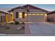 Well-maintained home featuring a two-car garage and desert landscaping at 12660 E Pivot Peak --, Gold Canyon, AZ 85118