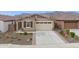 Exterior of home featuring a two car garage, desert landscaping, and mountain views at 12660 E Pivot Peak --, Gold Canyon, AZ 85118