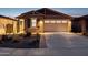 Home exterior featuring a two car garage, desert landscaping, and craftsman shutters at 12660 E Pivot Peak --, Gold Canyon, AZ 85118