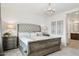 Well-lit main bedroom showcases a tufted headboard, chandelier, and stylish nightstands at 12660 E Pivot Peak --, Gold Canyon, AZ 85118