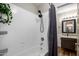 Bathtub and shower featuring modern fixtures, and a glimpse of a vanity sink at 1310 S Pima -- # 35, Mesa, AZ 85210