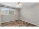 Bright bedroom featuring hardwood floors and a large window for natural light at 1310 S Pima -- # 35, Mesa, AZ 85210