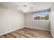 Bright bedroom showcasing sleek hardwood floors, a window, and a fan at 1310 S Pima -- # 35, Mesa, AZ 85210