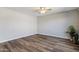 Spacious bedroom featuring elegant wood floors, a ceiling fan, and modern accent wall at 1310 S Pima -- # 35, Mesa, AZ 85210