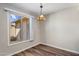 Cozy dining area with natural light from a large window, and luxury vinyl plank flooring at 1310 S Pima -- # 35, Mesa, AZ 85210