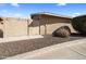 Exterior view of the home with a wooden gate and a gravel area at 1310 S Pima -- # 35, Mesa, AZ 85210