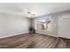 Bright living room featuring wood floors, geometric wall design, and a large window at 1310 S Pima -- # 35, Mesa, AZ 85210