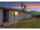 This single-story home features a flat backyard with minimal landscaping, access door, and a low-pitched roof at 1324 W 15Th St, Tempe, AZ 85281